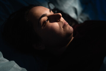 Close-up of woman face in night light. Girl drifts off sleep in her bed. insomnia, sleep disorder, poor rest and sleepless nights © Andrii Lysenko