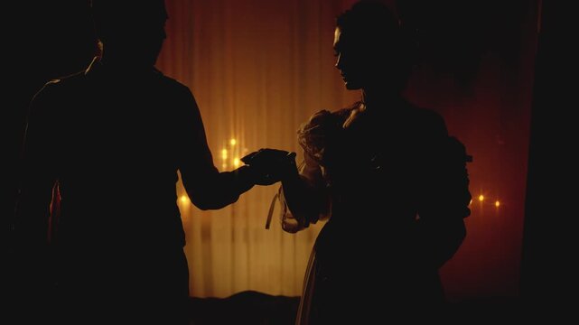 Black shadow silhouette two person happy couple together man king holiding hand sexy noble woman queen. night dark room candles light. Adult girl guy old style clothes, love medieval ball themed party