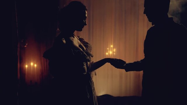 Black silhouette two gothic person, happy couple together man king kissing hand sexy noble woman queen. night dark room candles light. Adult girl guy old style clothes, love medieval ball themed party