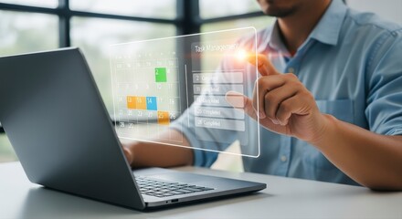 Businessman using task management software on laptop with interactive calendar