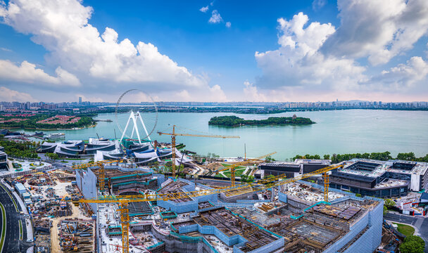 Construction site with tower cranes building modern architecture near Jinji Lake in Suzhou.