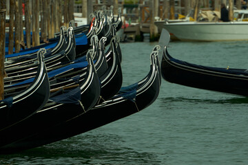 Venetian gondolas lining canal in venice italy © Alessandro