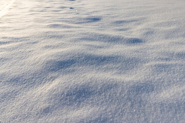 large deep fresh snowdrifts of white color in the field during the winter , large soft snowdrifts after large snowfalls in sunny weather, snow structure in sunlight