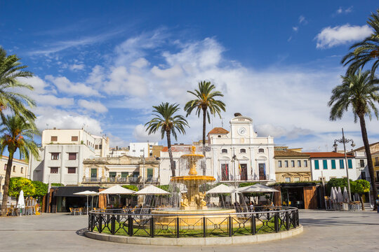 Palm trees and a fountain on the Plaza de Espana square in Merida, Spain