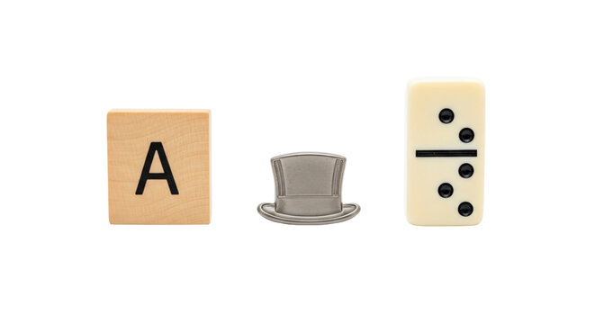 A scrabble tile a domino and a metal clip on a white background isolated on transparent background
