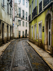 Fototapeta premium Colourful facades in a narrow alley in the old town of Lisbon, Portugal.