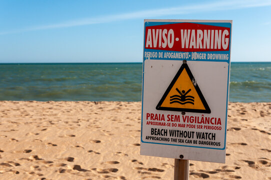 Sign warning visitors that there are no lifeguards on duty and that the sea can be dangerous, Vilamoura, Algarve, Portugal.