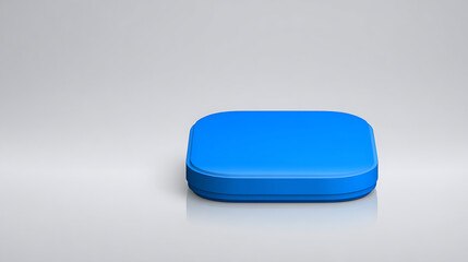 A bright blue geometric object on a plain white surface