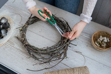 Step by step instruction of making handmade Easter wreath made of sustainable materials decorations in yellow color. Female hands creating craft homemade decor. Easter celebration gift present ideas © anna.stasiia
