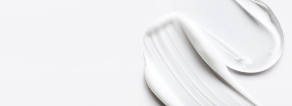 samples of cosmetic care products smear of cream and gel texture on a light background