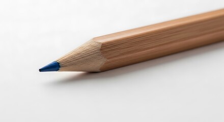 Obraz premium A sharpened wooden pencil with a blue lead tip against a plain background.