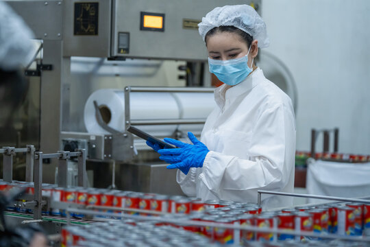 Canned food production line with inspector checking cans using tablet