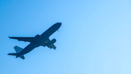 Fototapeta premium Airplane Silhouette Flying Against Clear Blue Sky Copy Space