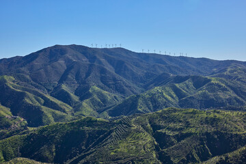 Wind turbines generating clean energy on mountain ridge