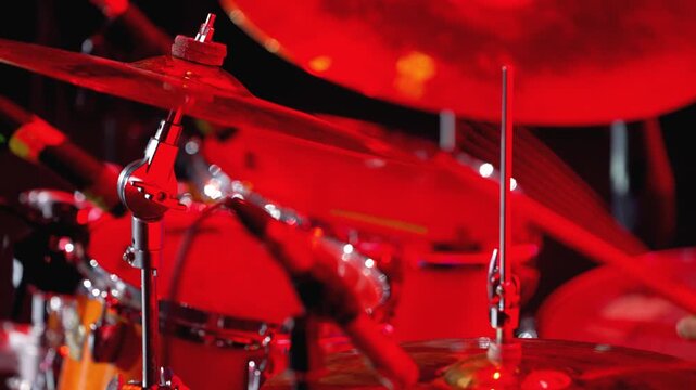 Drummer plays the drum with wooden sticks. Male drummer playing drum kit. Drummer's hand play during party