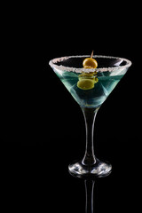 Blue cocktail martini glass with olive garnish