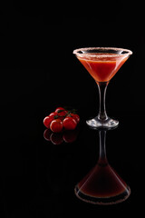 Bloody mary cocktail with cherry tomatoes on black