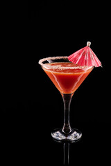 Refreshing red cocktail in martini glass with umbrella