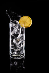 Refreshing water drink splashing with lemon and ice