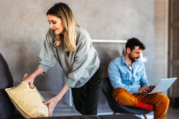 Young diverse couple moving in new home. Couple is having fun in new house at moving day