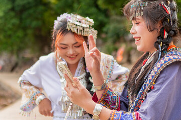 Obraz premium Young Chinese women creating social media content outdoors