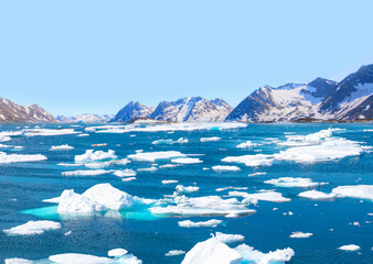 Melting icebergs by the coast of Greenland, on a beautiful summer day - Melting of a iceberg and...