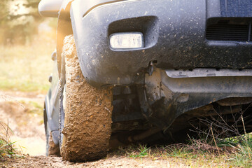A dynamic shot of an SUV navigating challenging, natural terrain. Perfect for travel, off-road, adventure, and automotive themes. © jarizPJ