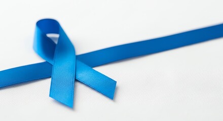 Blue awareness ribbon on a white background symbolizing support and hope.