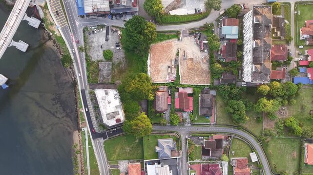 Johor Bahru residential area with houses and a body of water in the background