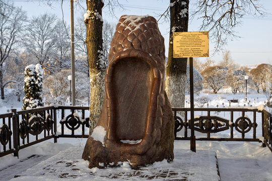Monument to the Russian lapty (bast shoe), the city of Vyazma, Smolensk region, Russia - January 18, 2026. The genre sculpture "Russian Lapot" is made of red granite. A popular tourist attraction.