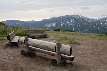 Wooden benches in the mountains. Recreation area on a mountain pass. Travel, tourism and hiking on the Kamchatka Peninsula. Beautiful nature of Siberia and the Russian Far East. Kamchatka Krai, Russia