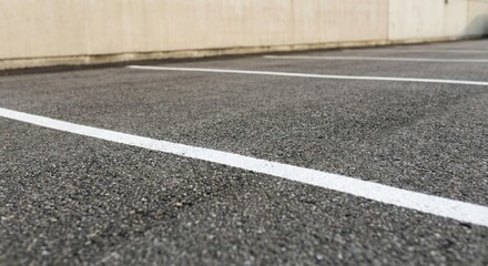 Asphalt Parking Lot Lines White Painted Marks on Pavement Surface Concrete Wall Backdrop Ground Texture Detail Outdoor Scene