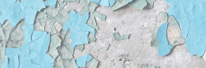 Peeling paint on the wall. Old concrete wall with cracked flaking paint. Weathered rough painted surface with patterns of cracks and peeling. High resolution texture for background and design. Closeup