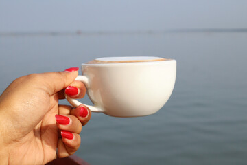 Coffee latte milk foam cup on hand