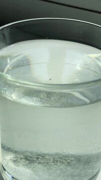 water surface.Epsom salt. Salt. Glass. Glass of water. Epsom salt. Slow motion video. High quality 4k footage
