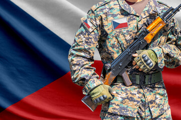 Obraz premium Czech flag with soldier in military uniform holding assault rifle in front of it