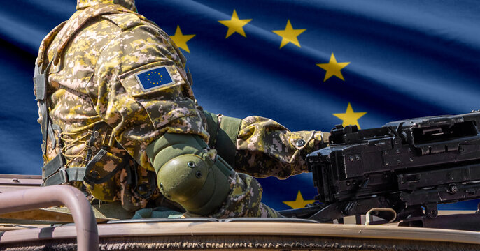 European union flag with soldier at machine gun turret in front of it. Closeup side view.