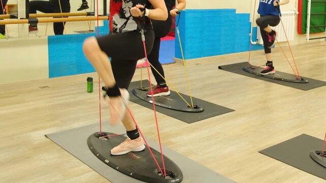 Moscow, Russia, 25.02.2025 Woman exercising with balance platform during fitness workout. Functional training for core strength and stability in gym.