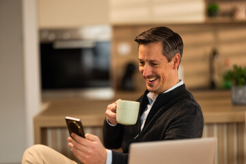 Man Checking Social While Drinking Coffee