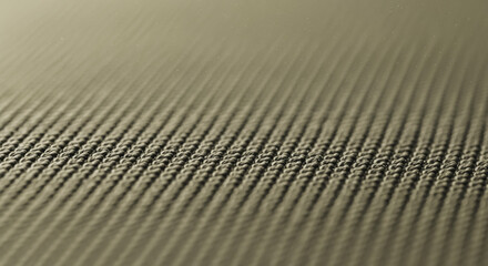 Detailed close-up of a textured woven fabric surface with repeating patterns and a soft, muted color palette, showcasing fine threads and shallow depth of field.