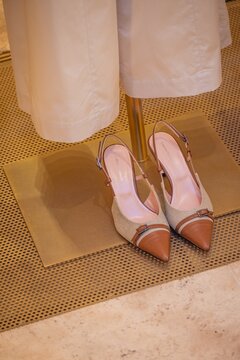 Milan, Italy - 2026, 17 Feb: Elegant Lorena Antonazzi SS26 slingback heels in beige and brown displayed in a chic boutique, highlighting refined Italian fashion style