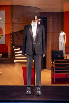 Milan, Italy - 2026, 17 Feb: McQueen SS26 window display features a sleek black tuxedo, modern tailoring, and luxury details in a chic boutique setting