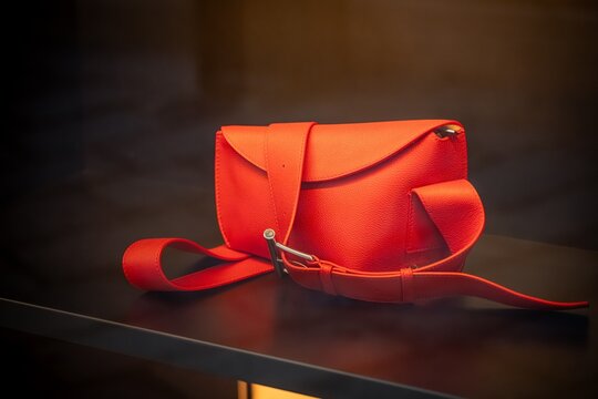 Milan, Italy - 2026, 17 Feb: Vibrant red McQueen handbag from SS26 collection, showcasing bold design and luxury craftsmanship in a modern display
