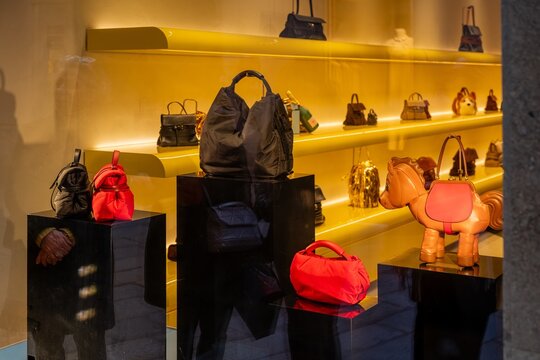 Milan, Italy - 2026, 17 Feb: Moschino SS26 handbags in a vibrant boutique display, featuring bold colors, unique shapes, and modern Italian luxury style