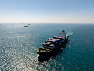 Aerial View Of Large Container Ship Navigating Open Ocean With Distant Vessels On Horizon