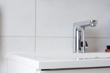 Modern white bathroom sink with sleek chrome faucet, clean and minimalist design.