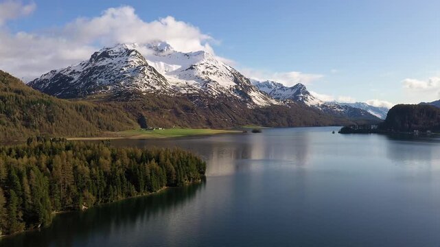 Sils, Switzerland: Aerial drone footage of the Sils lake, the Silsersee, and the Corvatch mountain in the stunning Engadine valley in the alps in Canton Graubunden (Grisons) in Switzerland