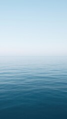 Obraz premium Calm ocean under clear sky.