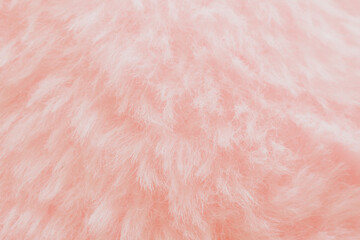 Soft pink plush fabric background with long fuzzy fibers, macro shot of delicate textile surface for romantic design or beauty backdrop © moryachka