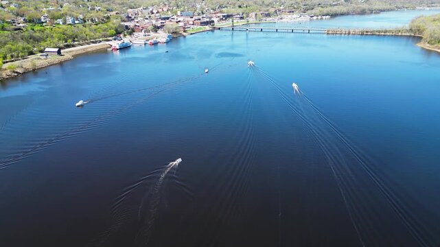 Aerial telephoto shot of the St. Croix River and boats on the water in Stillwater, Minnesota. 4K